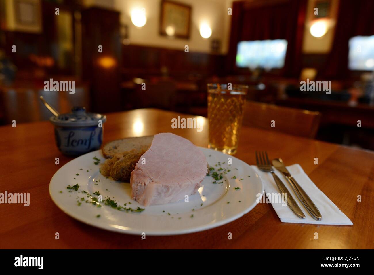A glass of cider with a plate of loin ribs, bread and a pot of mustard are seen in a typical Frankfurt cider tavern on 21.11.2013. Photo: Frank May Stock Photo