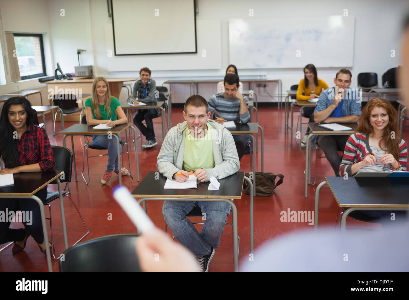 Students listening to their teacher in classroom Stock Photo