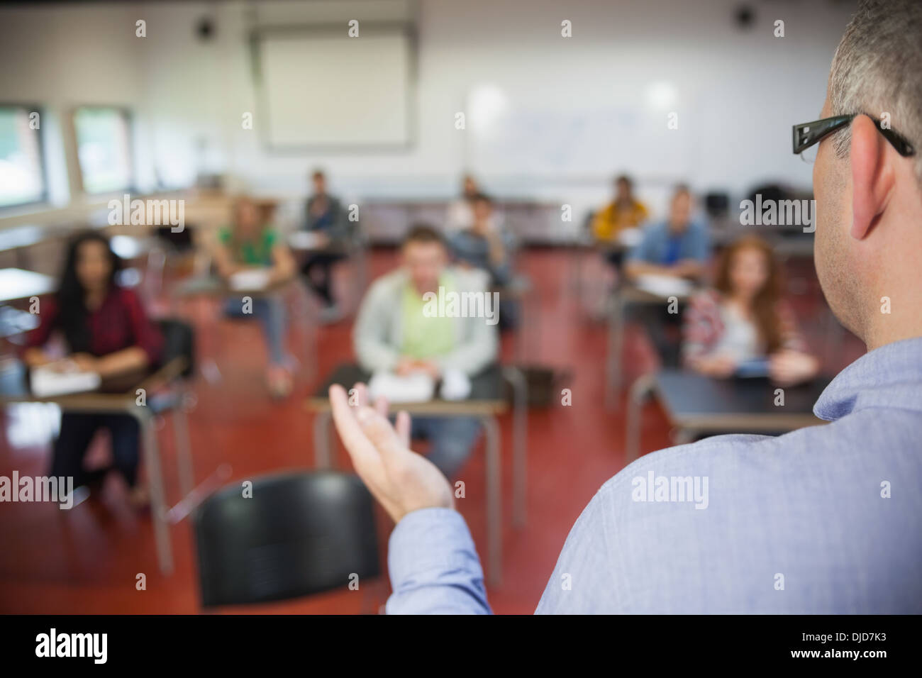 Lecturer speaking to his class of students Stock Photo