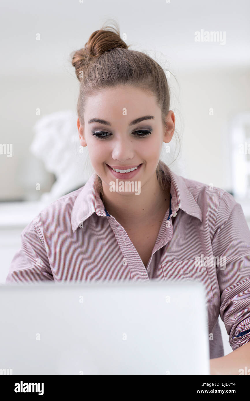 Portrait of smiling teenage girl using laptop Stock Photo - Alamy
