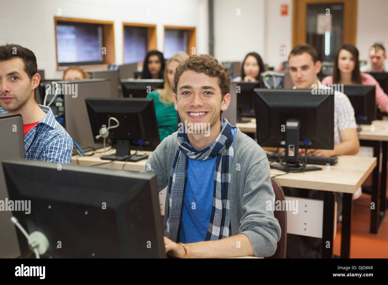 Cheerful students listening in their computer class Stock Photo