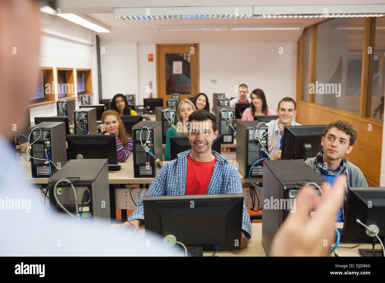 Cheerful students listening to lecturer in their computer class Stock Photo