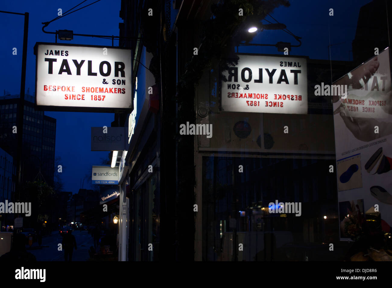 James Taylor & Son Bespoke Shoemakers Since 1857 sign outside shoe / shoemaker shop at dusk / night Marylebone London England UK Stock Photo