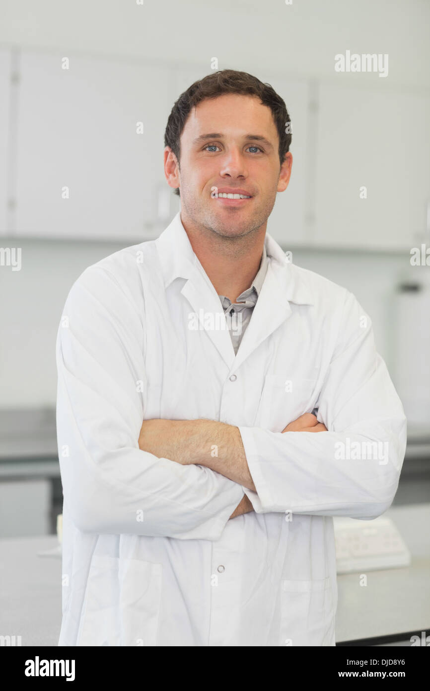 Attractive young scientist posing in laboratory with arms crossed Stock Photo