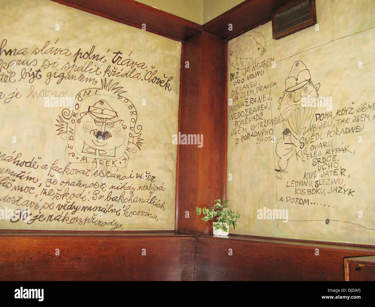 Cartoons on the wall from The Good Soldier Švejk at the U Kalicha Pub and Restaurant in Prague. Stock Photo