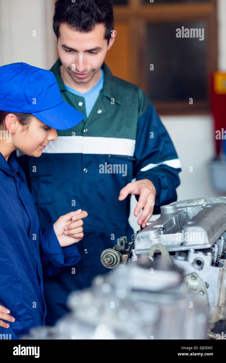 Content instructor explaining engine to trainee Stock Photo