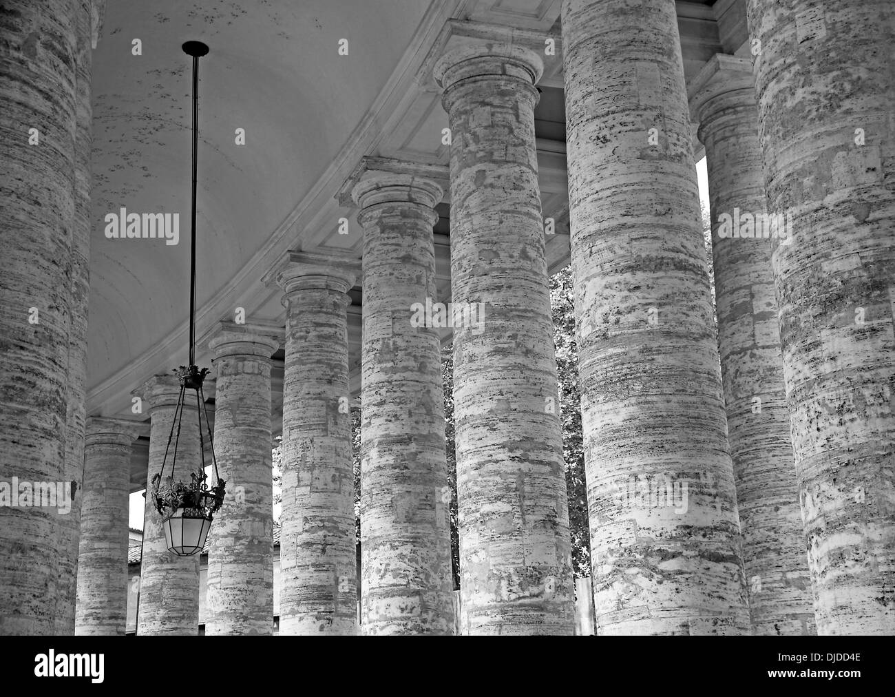 famous columns of Bernini's Colonnade in St. Peter's square in the Vatican in black and white Stock Photo