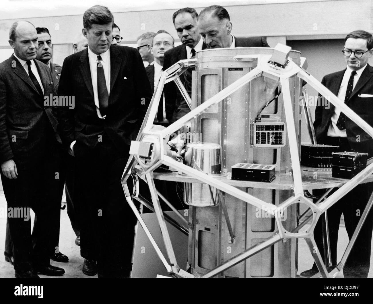 US President John Kennedy inspects the VELA satellite designed for the detection of atmospheric nuclear testing during a visit to Sandia National Labs December 7, 1962 in Albuquerque, NM. Visible behind the satellite are national security advisor McGeorge Bundy, Atomic Energy Commission chairman Glenn Seaborg, and Sandia President Sigmund Schwartz. Stock Photo