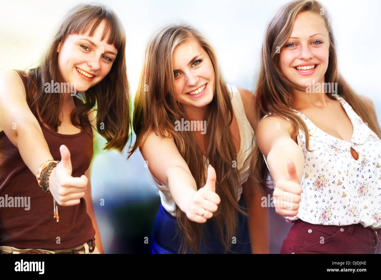 Beautiful student girls smiling and giving thumbs up Stock Photo - Alamy