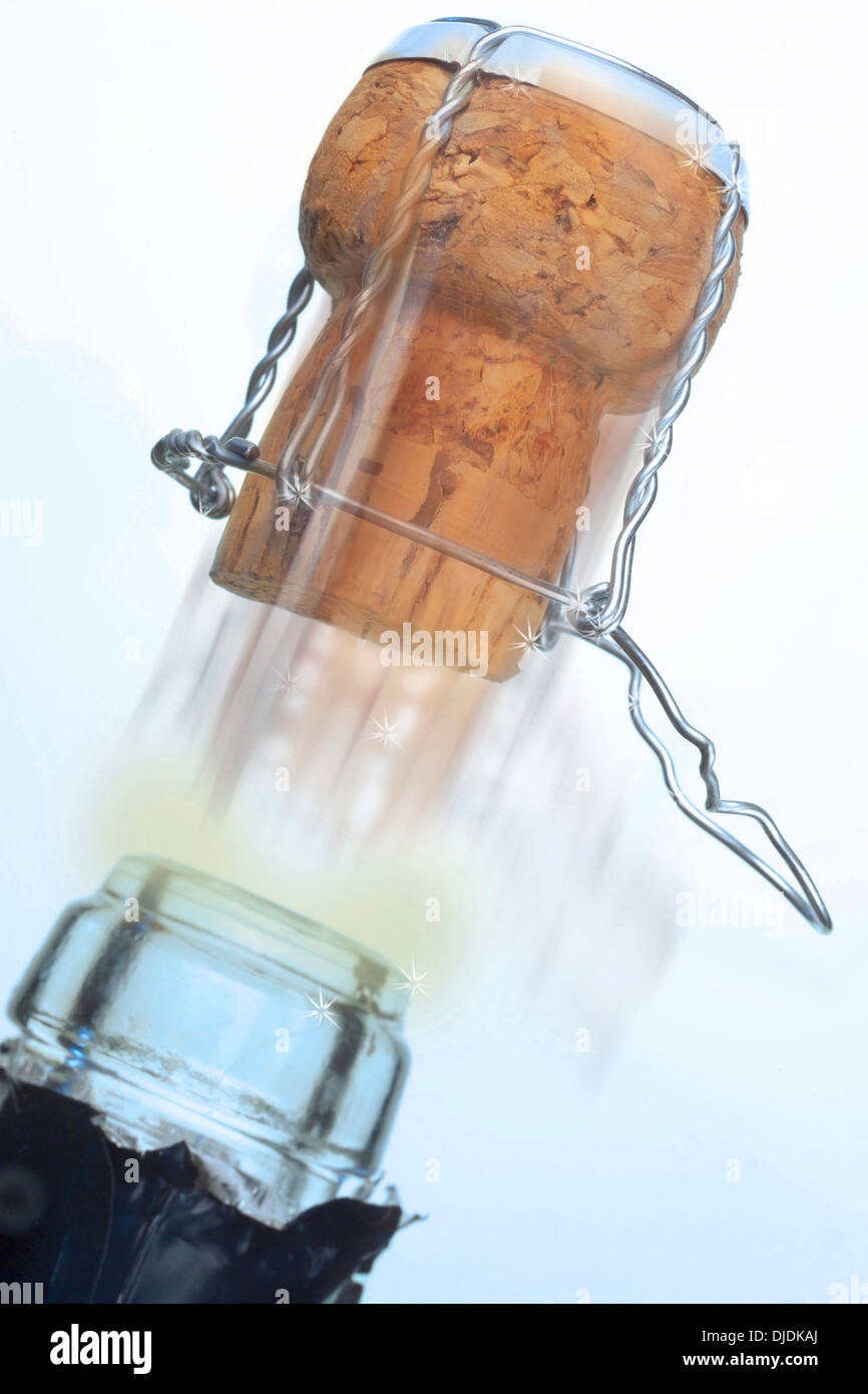 Champagne cork popping out of a champagne bottle Stock Photo
