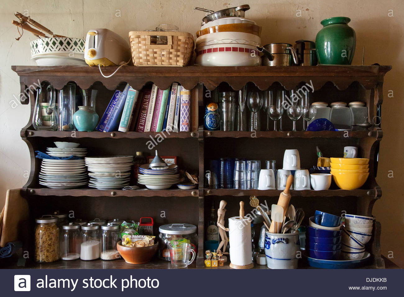 Messy Shelves In Kitchen Full Of Cookbooks Food And Dishes Stock