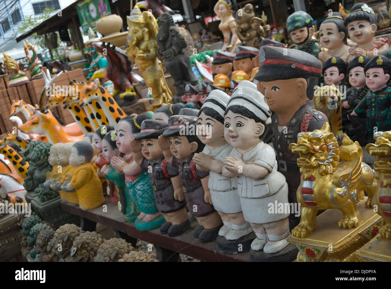 soldiers and nurses among the figures being sold as garden ornaments in a shop in phetchabun, thailand Stock Photo