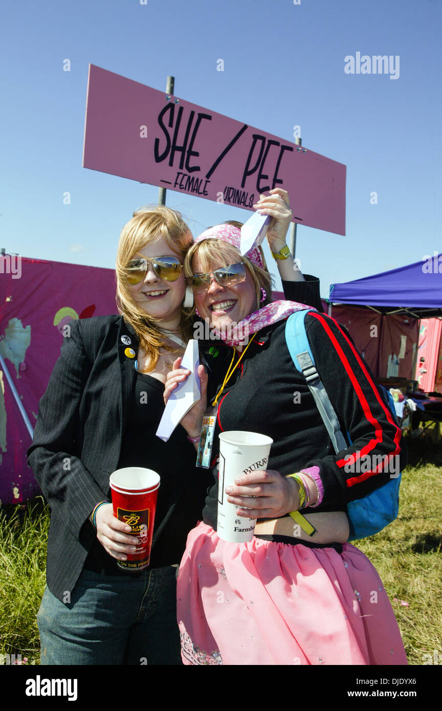 Women at the She pee female urinals at the Glastonbury music festival