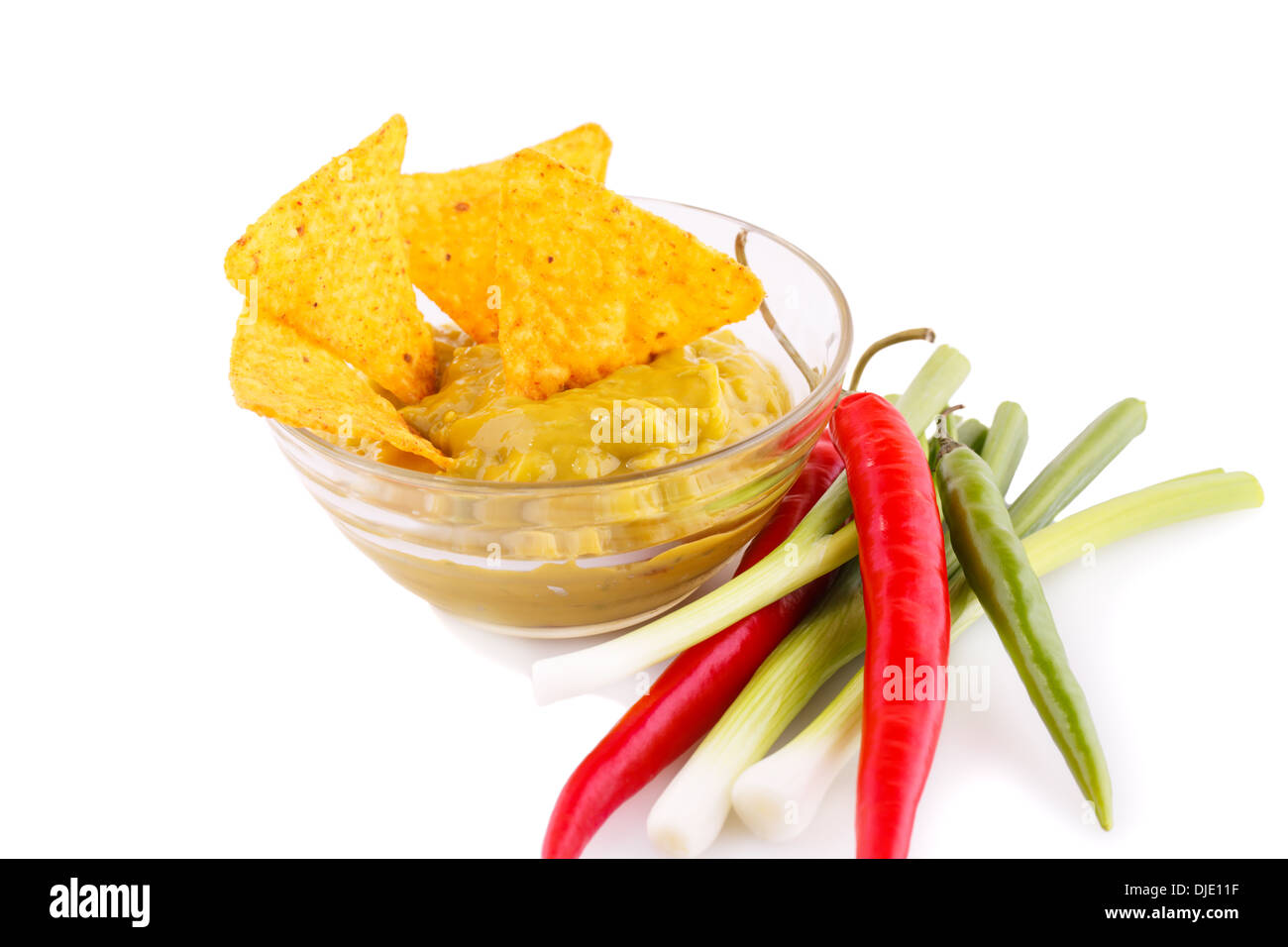 Nachos, guacamole sauce and vegetables isolated on white background. Stock Photo