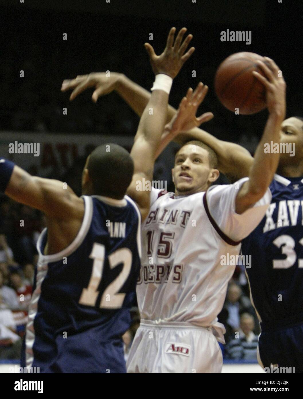 Mar 11, 2004; Dayton, OH; USA; Hawks guard DELONTE WEST (15) is fouled by Brandon Cole (33), right, as he goes to the basket in the 2nd half of the Atlantic 10 Championship Quarterfinal Round between the 27-0 Saint Joseph's Hawks and the Xavier Musketeers in Dayton, Ohio, Thursday, March 11, 2004. Xavier defeated the #1 ranked and undefeated St. Joseph's Hawks 87-67. Stock Photo