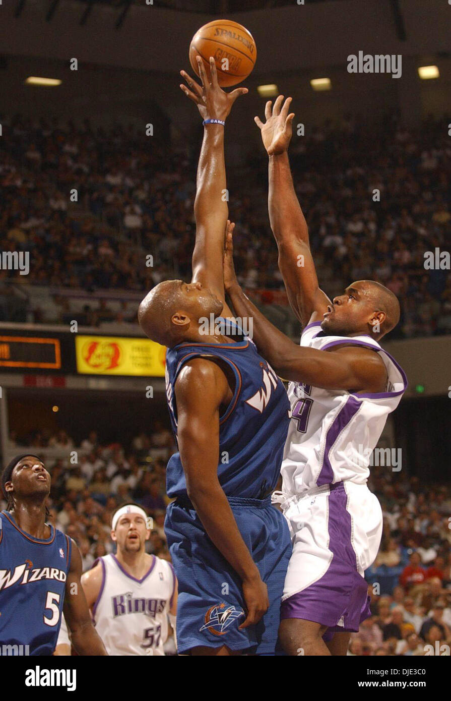 Mar 28, 2004; Sacramento, CA, USA; The Sacramento Kings CHRIS WEBBER (R) scores two of his 23, points against the Washington Wizards BRENDAN HAYWOOD at Arco Arena during the Kings 100 to 92 victory. Stock Photo