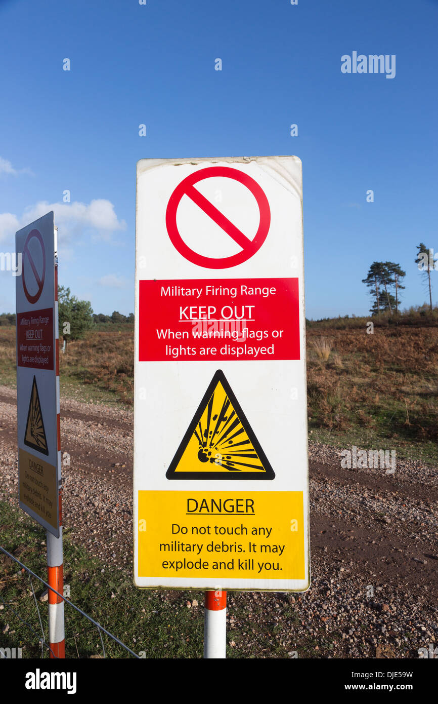 Warning signs on a military firing range at Ash Ranges, Surrey - danger of unexploded bombs and ordnance Stock Photo