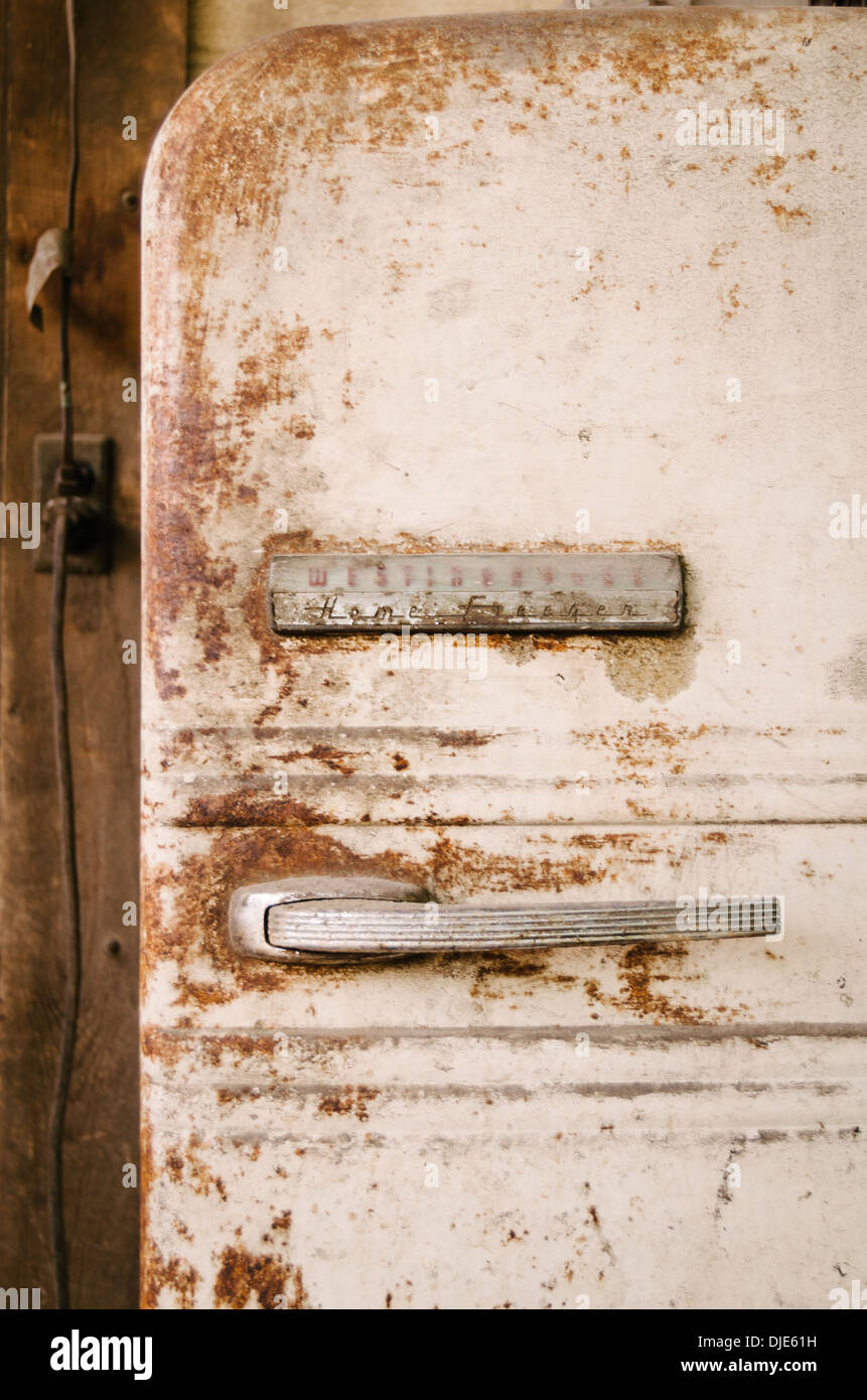 Rusty refrigerator on the back of a BBQ restaurant along route 281 in the hearth of Texas Hill Country. Stock Photo