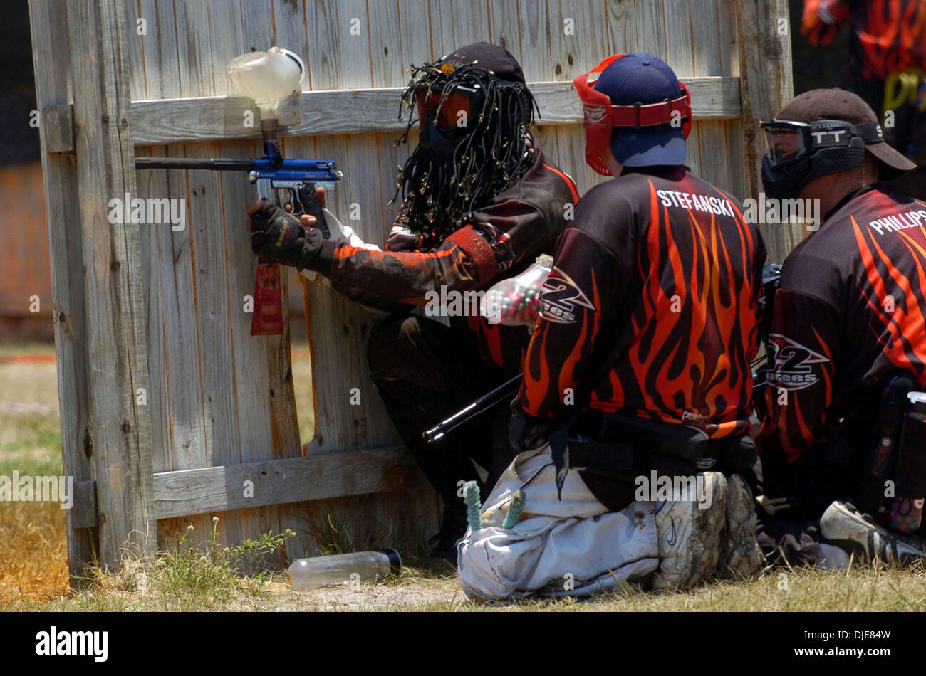 Jun 02, 2004; Palm Beach, FL, USA; Pasco County Firefighters JIMMY RODRIGUEZ (L) fires his is paintball air gun against Palm Beach Fire & Rescue during competition for the gold medal during the Florida State Fire Fighters games Wednesday June 2, 2004. Stock Photo