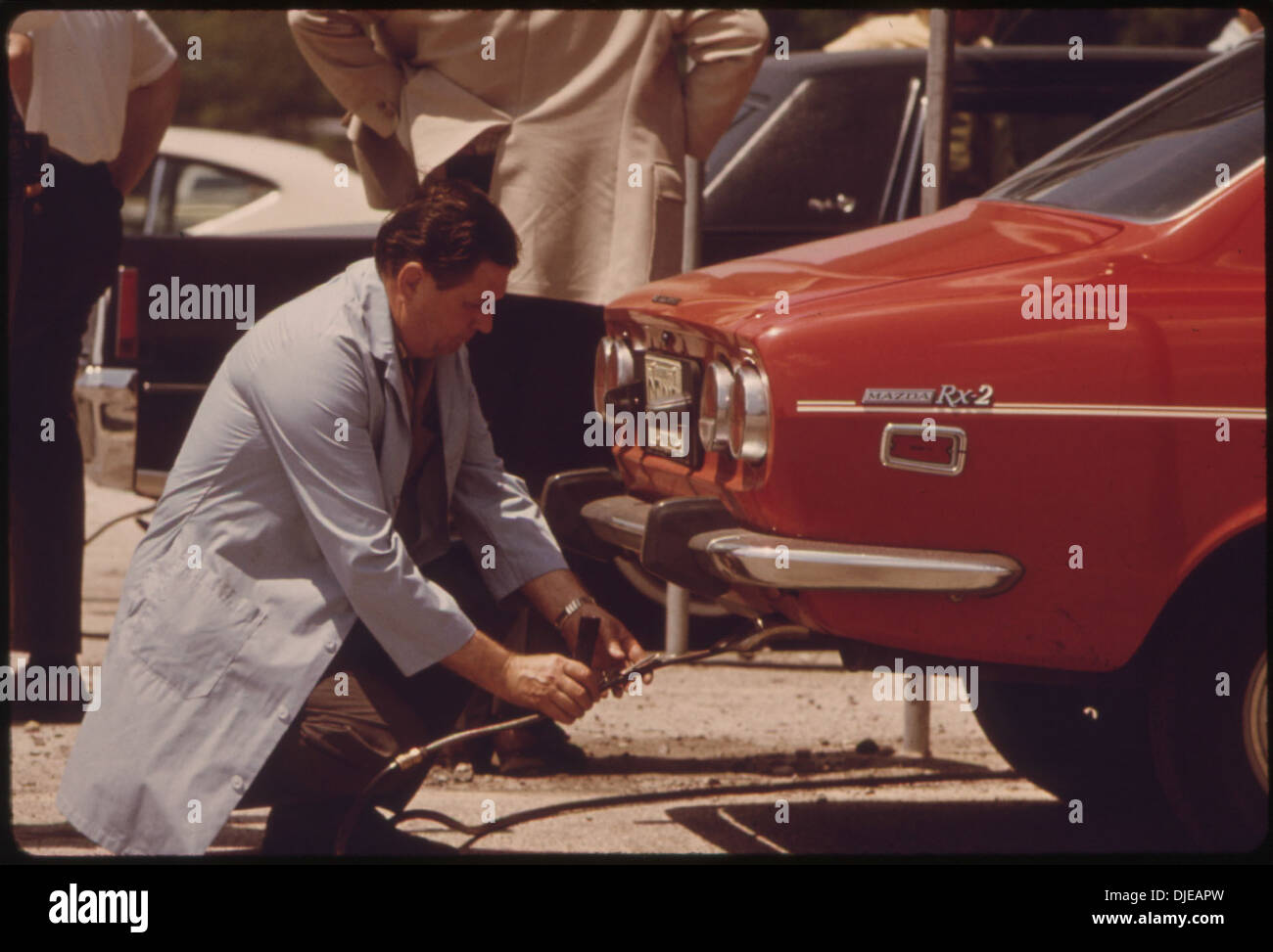INSPECTOR TESTING THE EXHAUST OF AN AUTO AT SOLDIER'S FIELD ONE OF NINE