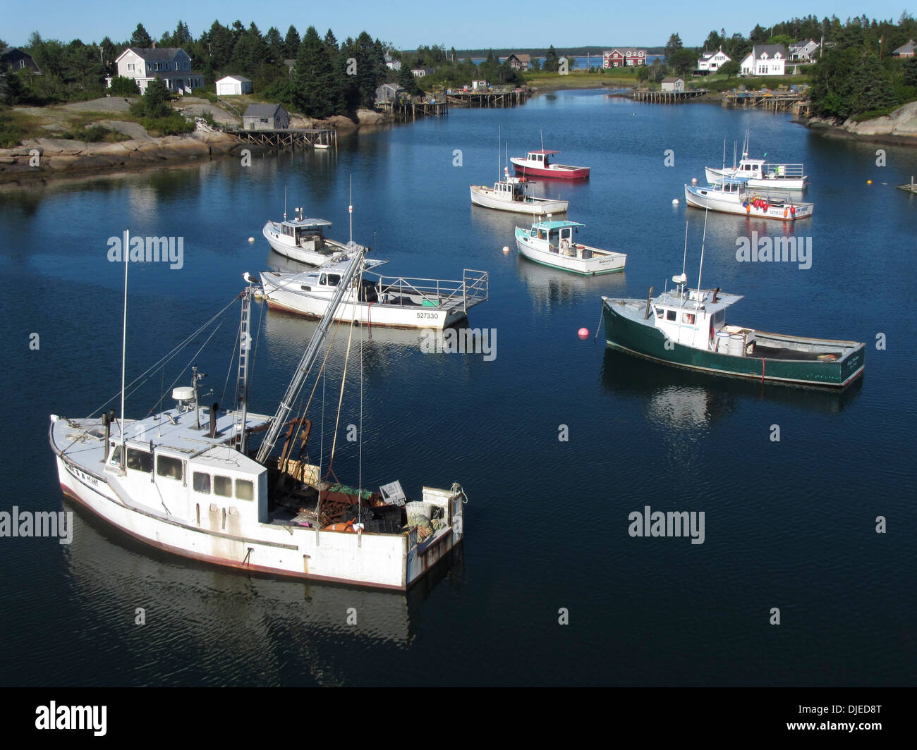 Traditional New England lobster boats moored on a cal sunny Sunday in Corea Maine, USA Stock Photo