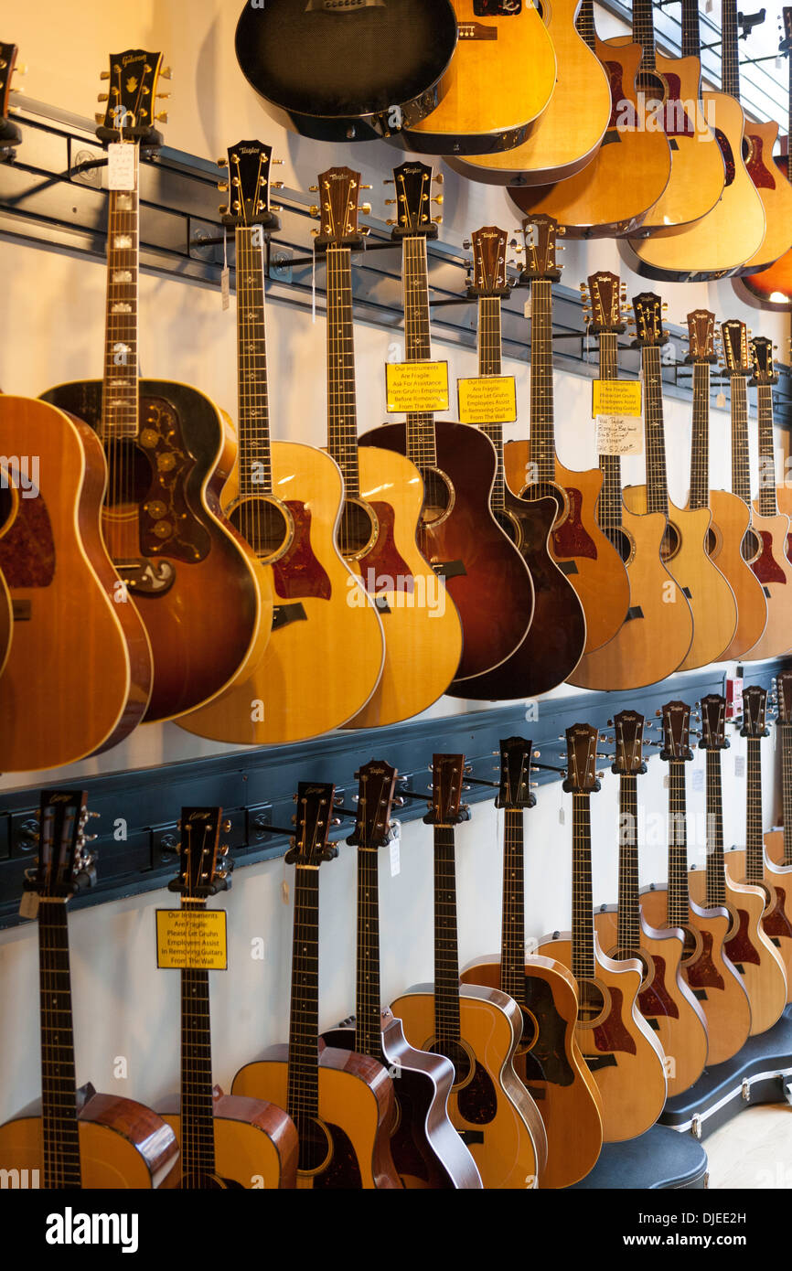 wooden acoustic guitars for sale in a music shop Stock Photo