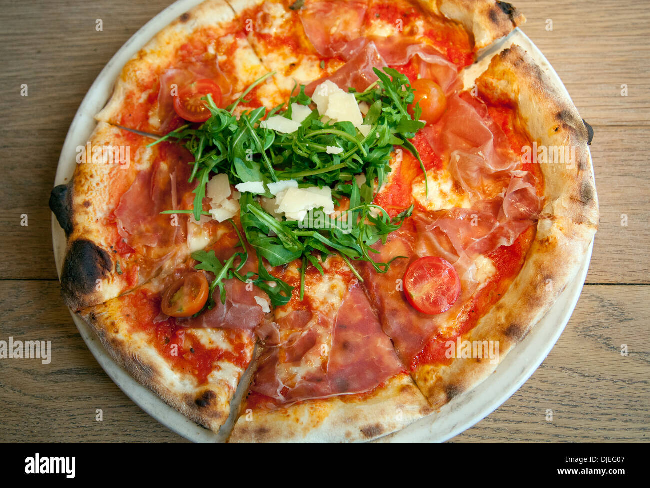 San Daniele Pizza with Rucola and Prosciutto Stock Photo