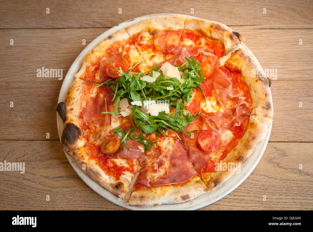 San Daniele Pizza with Rucola and Prosciutto Stock Photo