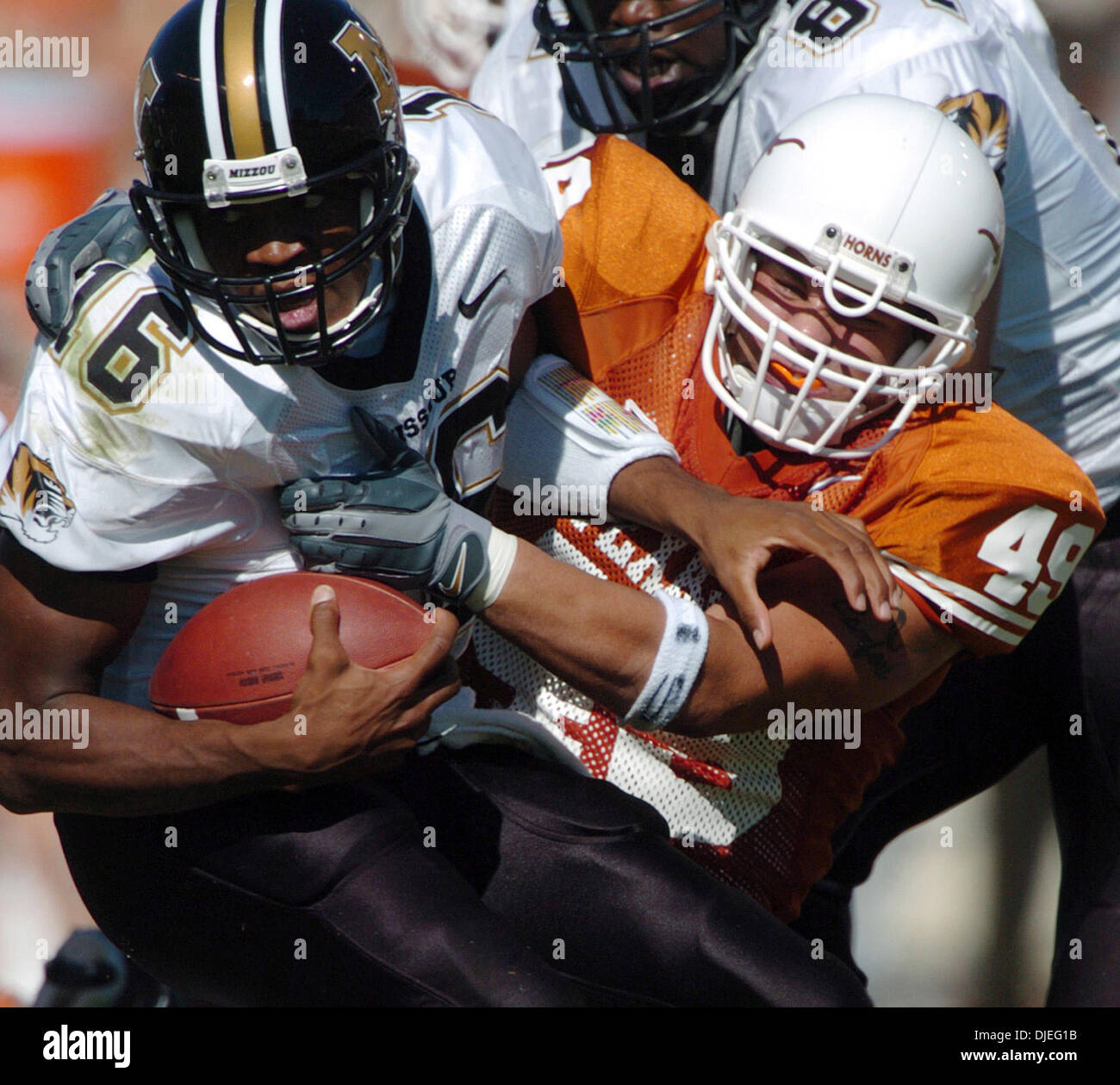 Oct 16, 2004; Austin, TX, USA; NCAA College Football - Texas vs Missouri - Texas linebacker Eric Hall tackles Missouri quarterback Brad Smith behind the line of scrimmage in the first half Saturday, October 16, 2004 at Memorial Stadium. Stock Photo