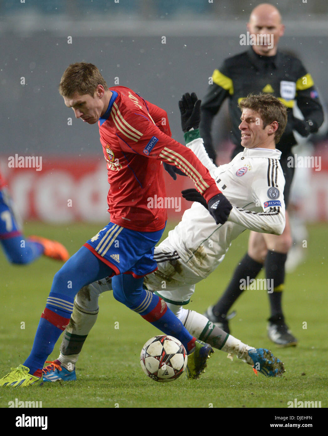 Moscow, Russia. 27th Nov, 2013. Moscow's Sergei Ignashevich (L) and Munich's Thomas Mueller vie for the ball during the UEFA Champions League Group D soccer match between CSKA Moscow and FC Bayern Munich at Arena Chimki in Moscow, Russia, 27 November 2013. Photo: Andreas Gebert/dpa/Alamy Live News Stock Photo