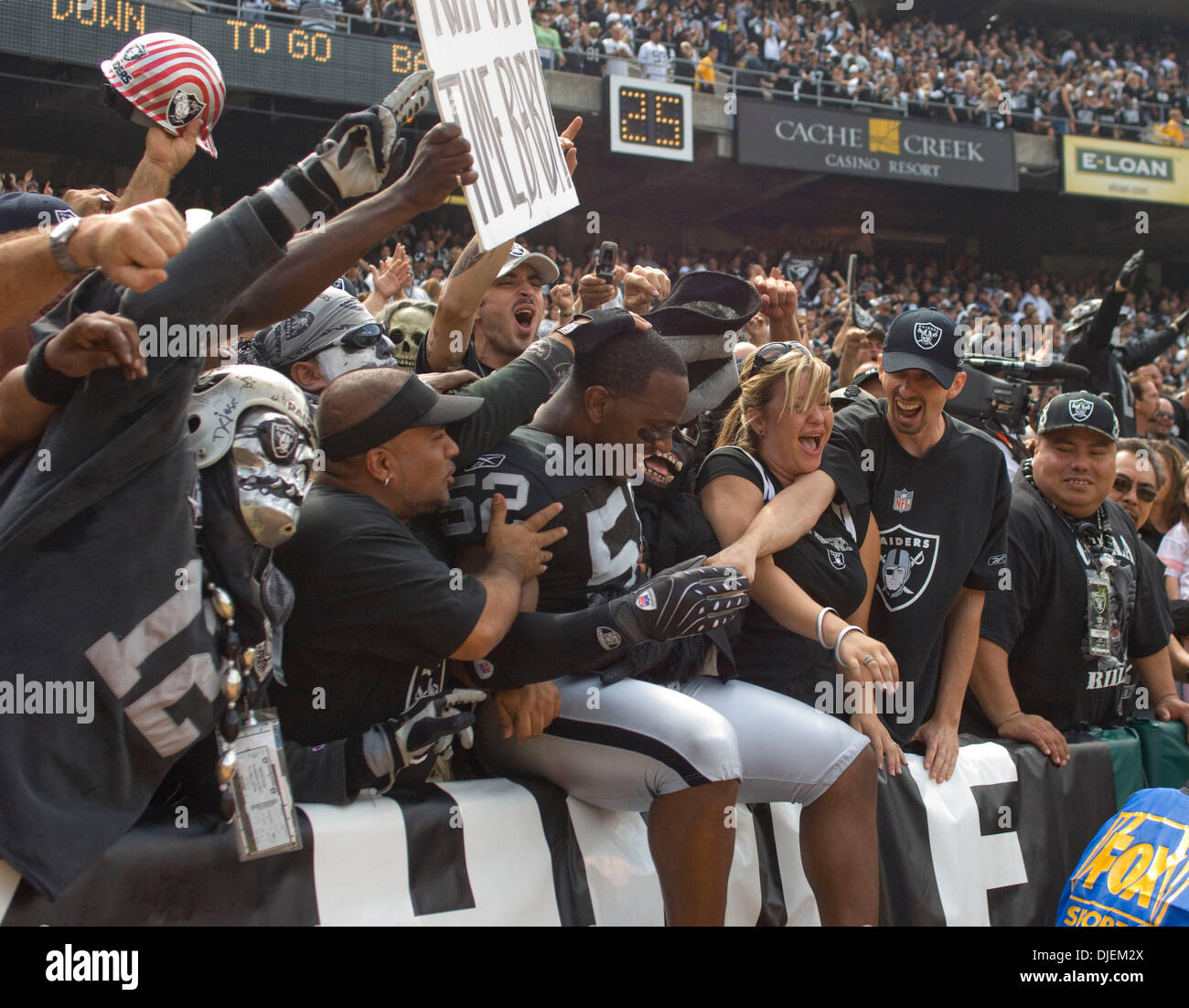 Sep 09, 2007 - OAKLAND, CA, USA - Oakland Raiders linebacker KIRK MORRISON  #52 jumps into the 'Black Hole' of McAfee Coliseum before the start of the  game against the Detroit Lions. (