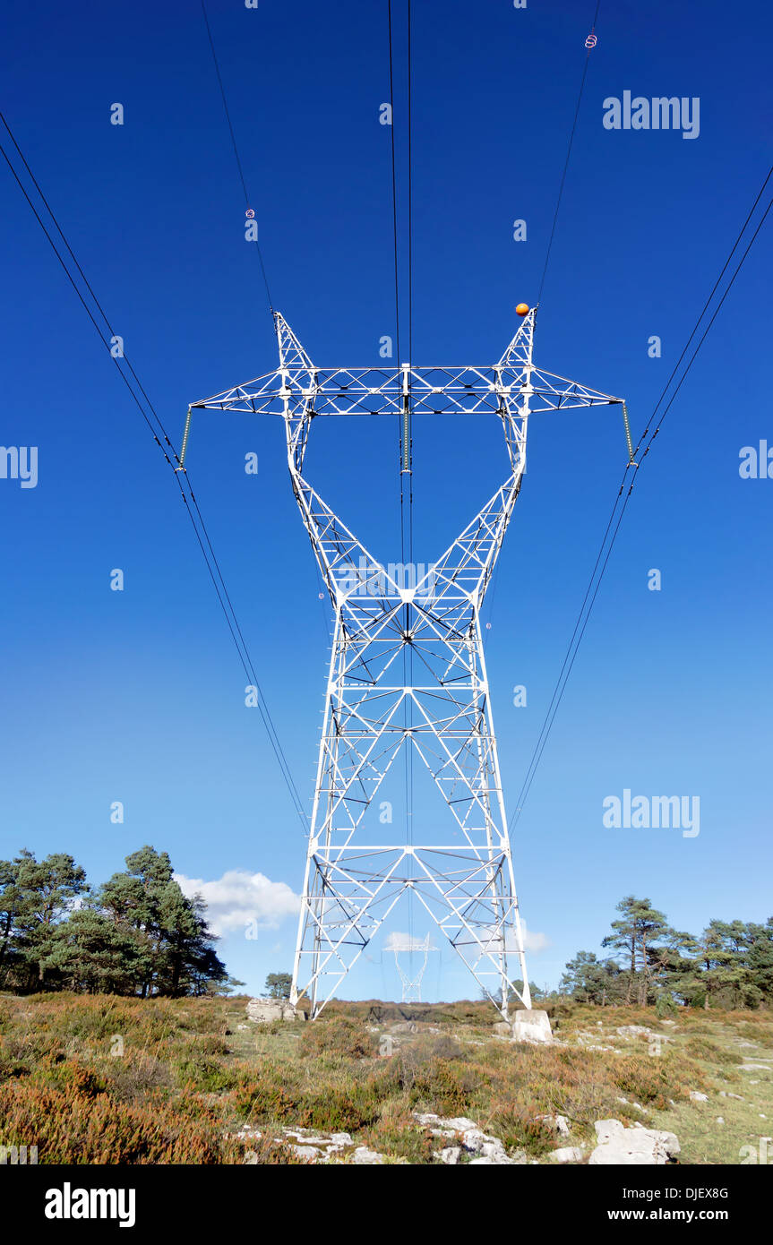 High voltage transmission tower against blue sky Stock Photo - Alamy