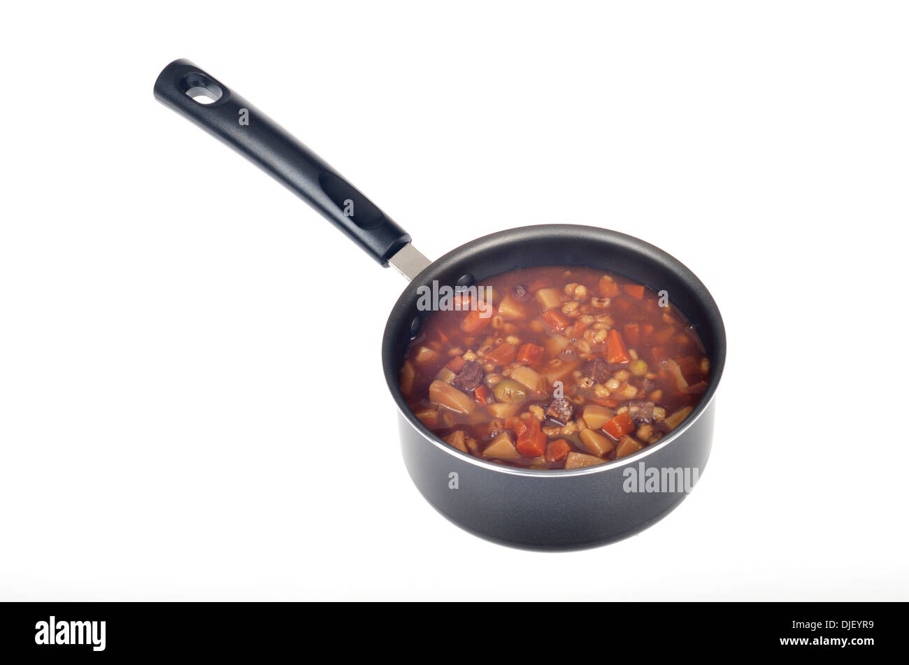 Pot of cooked vegetable beef soup on white background cutout. Stock Photo