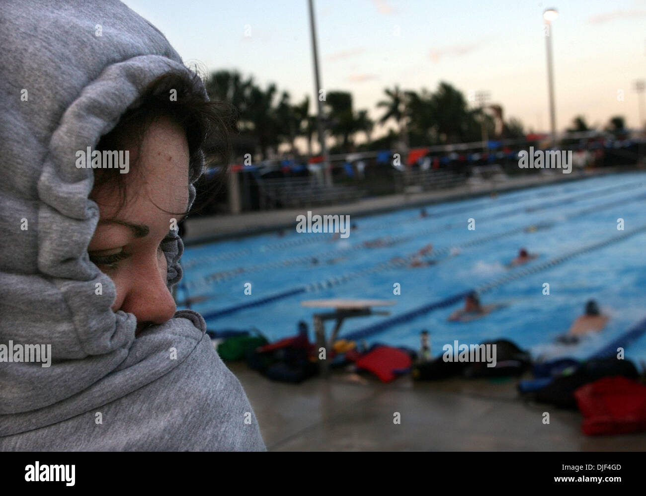 Jan 03, 2008 - Boca Raton, Florida, USA - Emory University trainer GINA SHIPMAN shivers under her sweatshirt as she watches her squad warm up for a swim meet between Florida Atlantic University, Emory University and Clemson University at the FAU Boca Raton campus Thursday, Jan. 3, 2008. Temperatures hovered near freezing when the sun rose. (Credit Image: © Chris Matula/Palm Beach P Stock Photo
