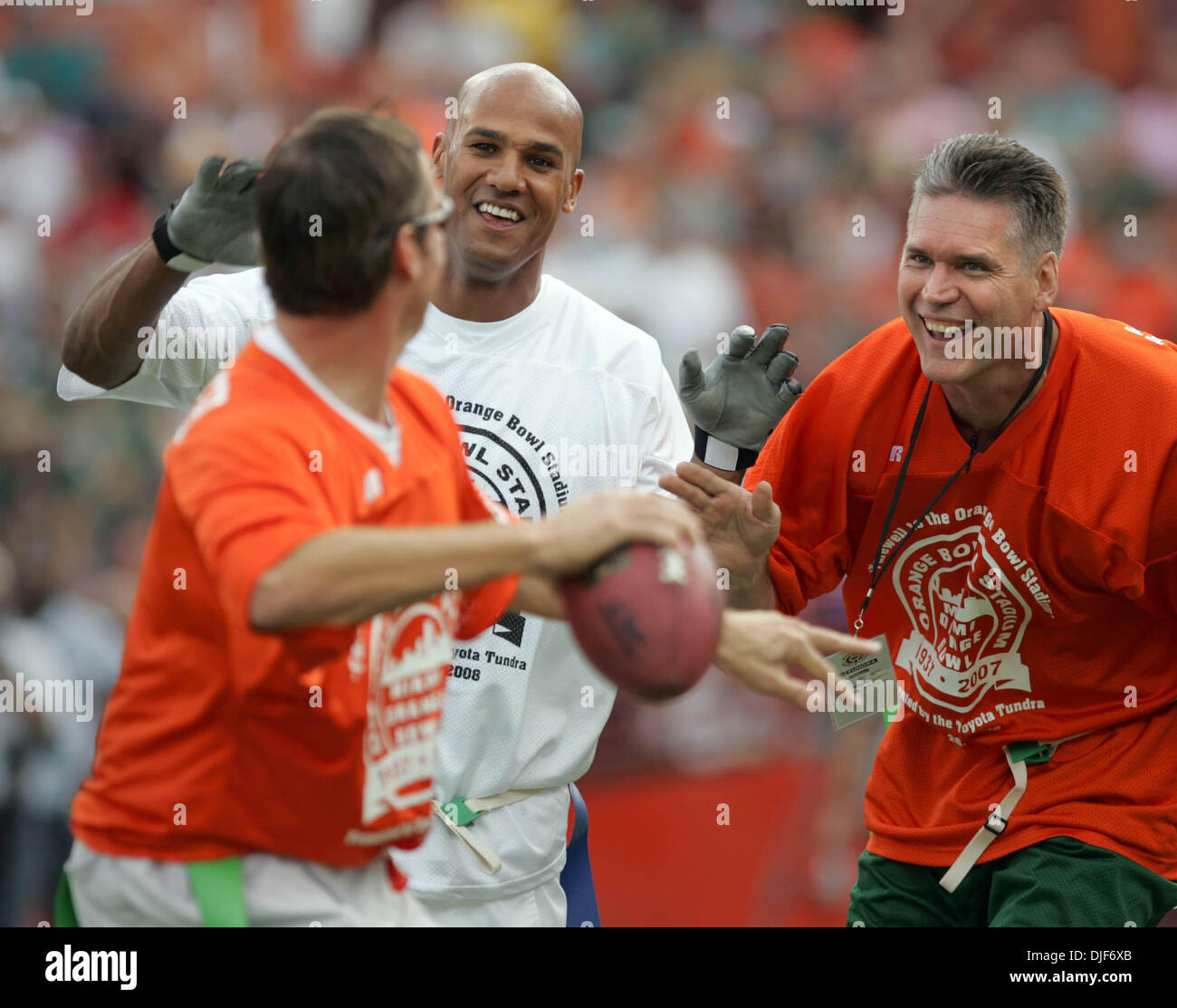 Jan 26, 2008 - Miami, Florida, USA - Former Miami Dolphin and U of Miami Hurricanes football stars play a 'Farewell to the Orange Bowl' flag football game in the Orange Bowl. PICTURED: JASON TAYLOR, center, gets past former Hurricane BILL HAWKINS, right, to pressure QB STEVE WALSH. (Credit Image: © Allen Eyestone/Palm Beach Post/ZUMA Pess) RESTRICTIONS: * USA Tabloids Rights OUT * Stock Photo