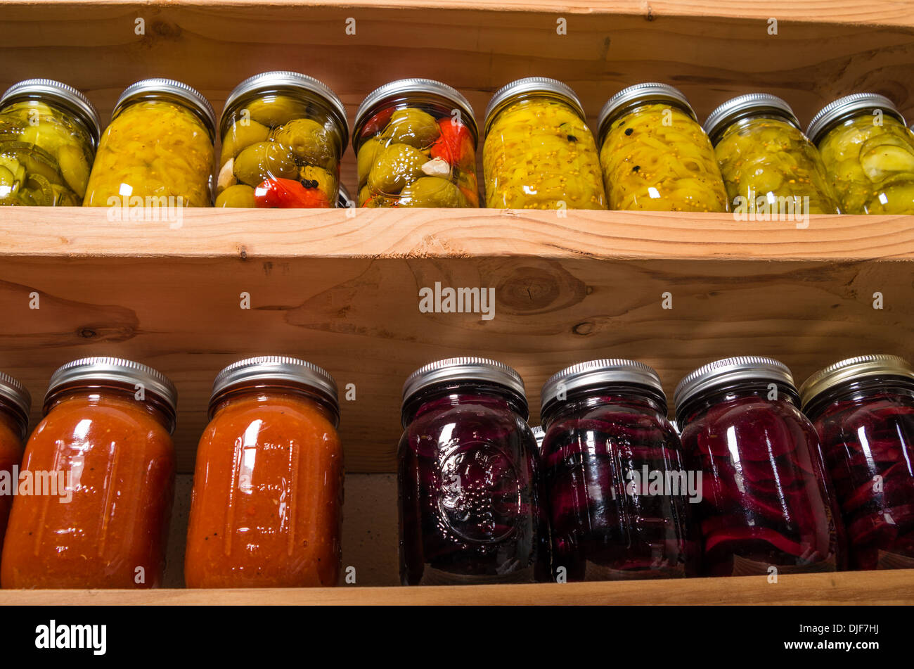 Canned goods on wooden storage shelves in pantry Stock Photo Alamy