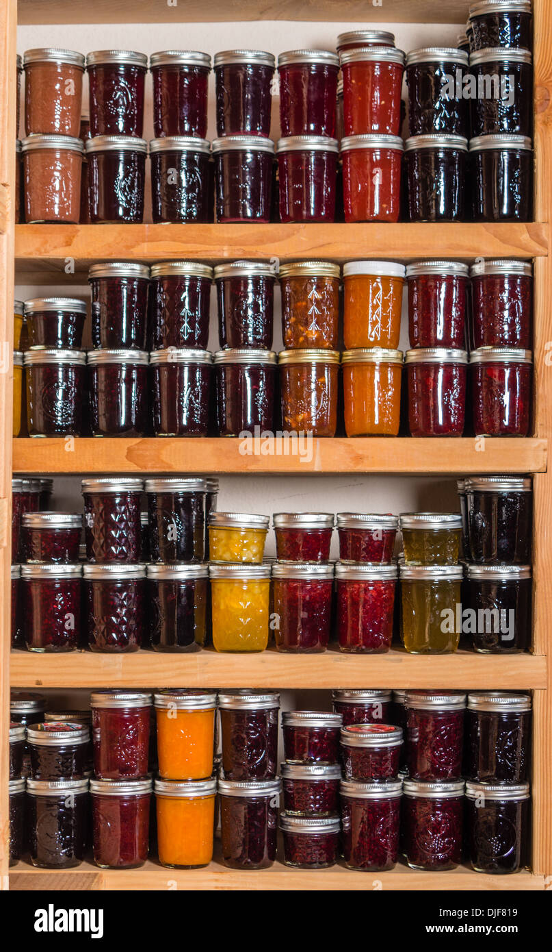 Canned Goods On Wooden Storage Shelves In Pantry Stock Photo