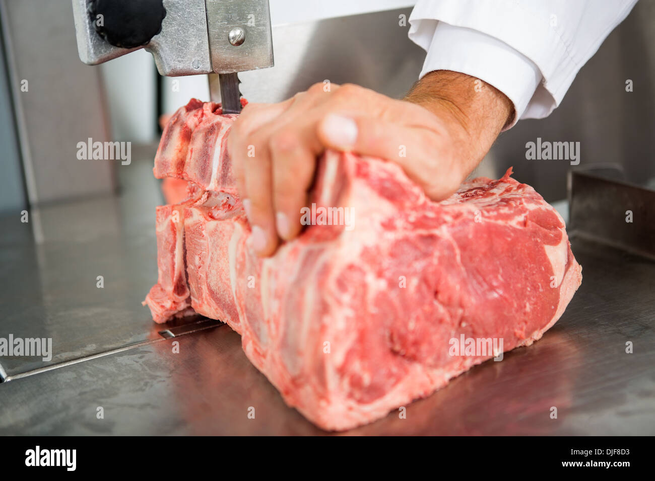 Hand Slicing Meat On Bandsaw Stock Photo