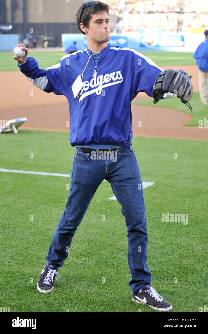 June 04, 2010 - Los Angeles, California, U.S - 04 June 2010: Rob Reiner's  son Jake Reiner helps his dad warm up before Rob throws out the first  pitch. The Los Angeles