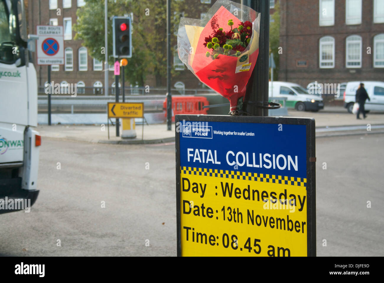 Police sign, flowers and traffic at Bow flyover, London Stock Photo