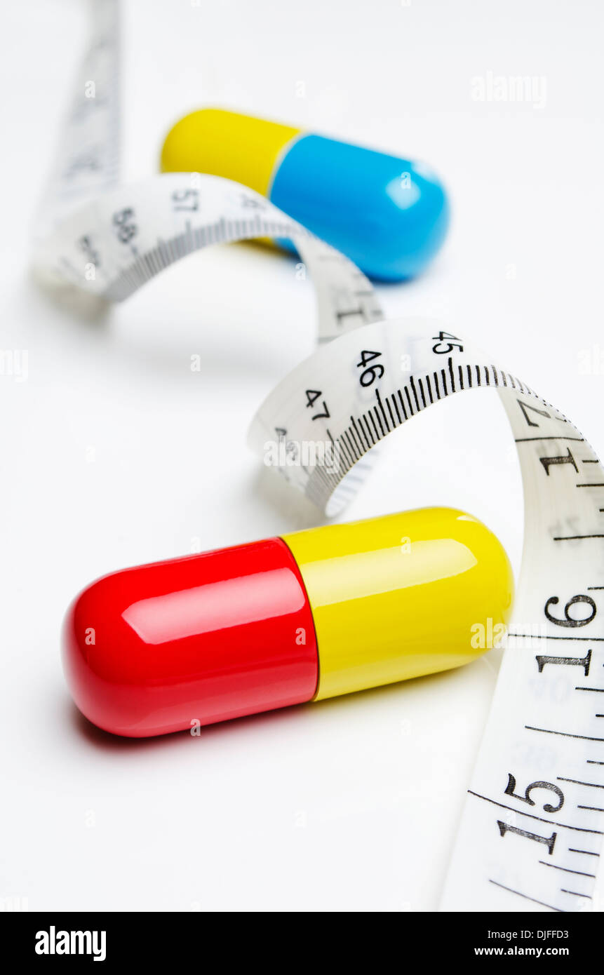 Giant pills and tape measure Stock Photo