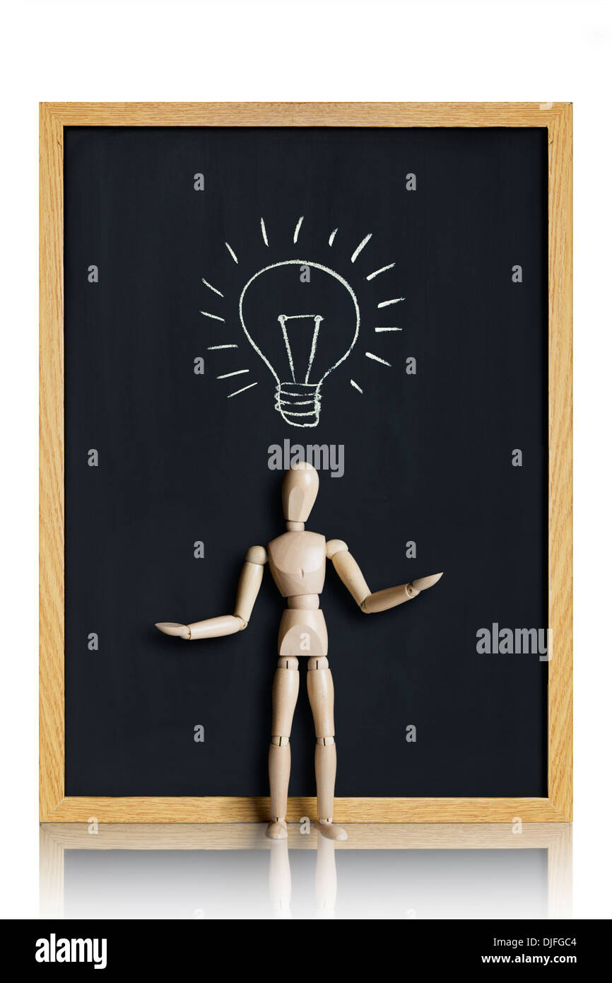 Bright idea. Manikin, anatomical model, placed on a chalkboard with a lightbulb drawn on it. Stock Photo