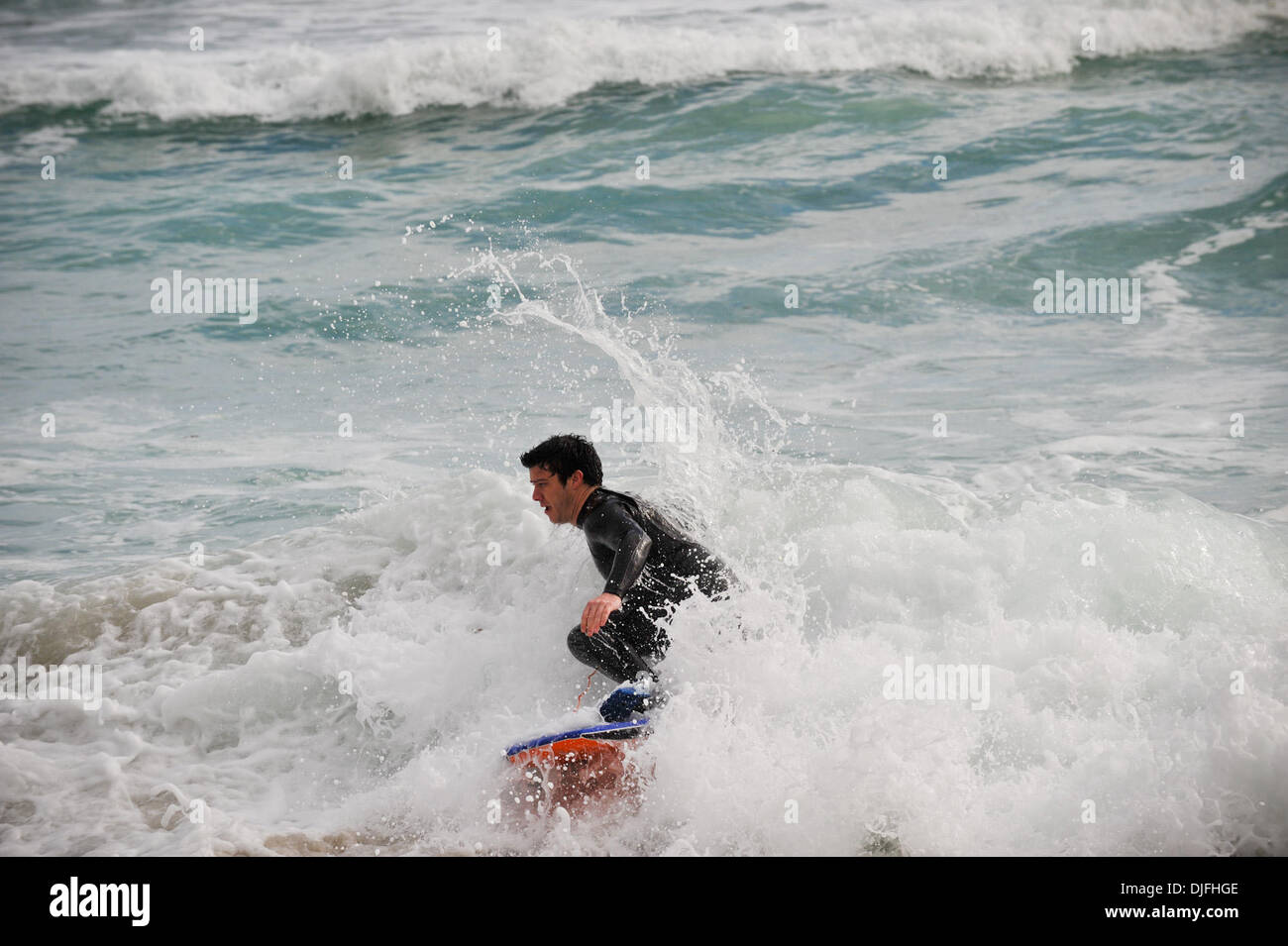 June 13, 2010 - Cape Town, SOUTH AFRICA - A body boarder rides the waves in the Camps Bay suburb of Cape Town Sunday, June 13, 2010 in South Africa. (Credit Image: © Mark Sobhani/ZUMApress.com) Stock Photo