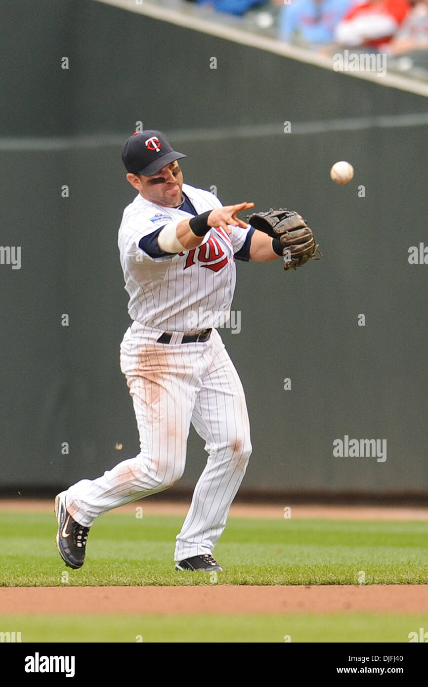 Minnesota Twins third baseman Nick Punto #8 throws on to first base for ...
