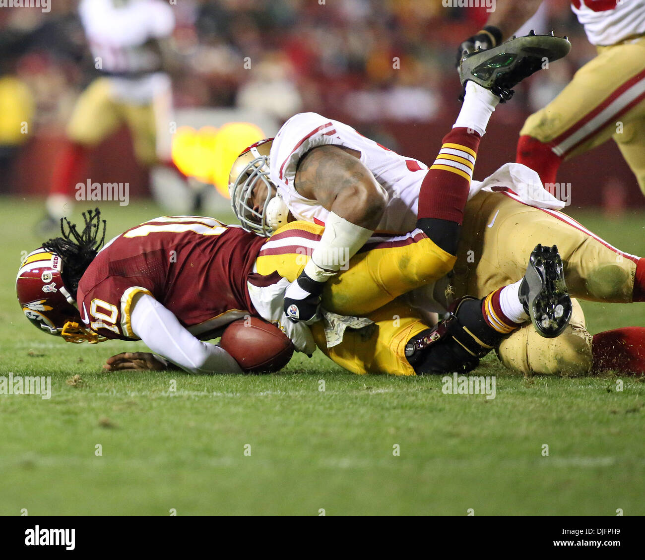 Landover, Maryland, USA. 25th Nov, 2013. San Francisco 49ers linebacker Ahmad Brooks (55) sacks Washington Redskins quarterback Robert Griffin III (10) during a regular season match between the Washington Redskins and the San Francisco 49ers at FedEx Field in Landover, Maryland. Credit:  Action Plus Sports/Alamy Live News Stock Photo