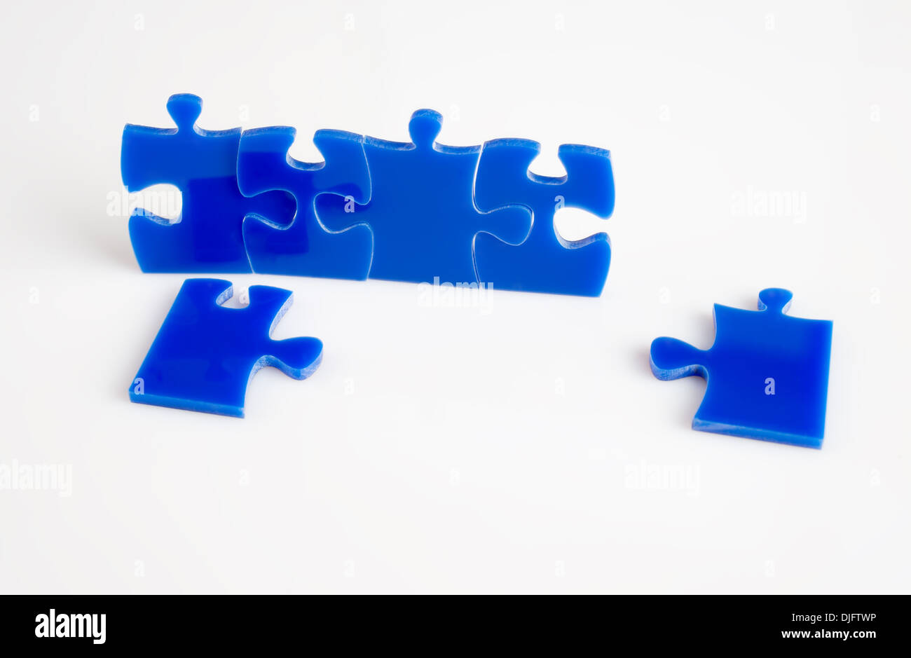 Blue Jigsaw puzzles blocks isolated on a white background Stock Photo