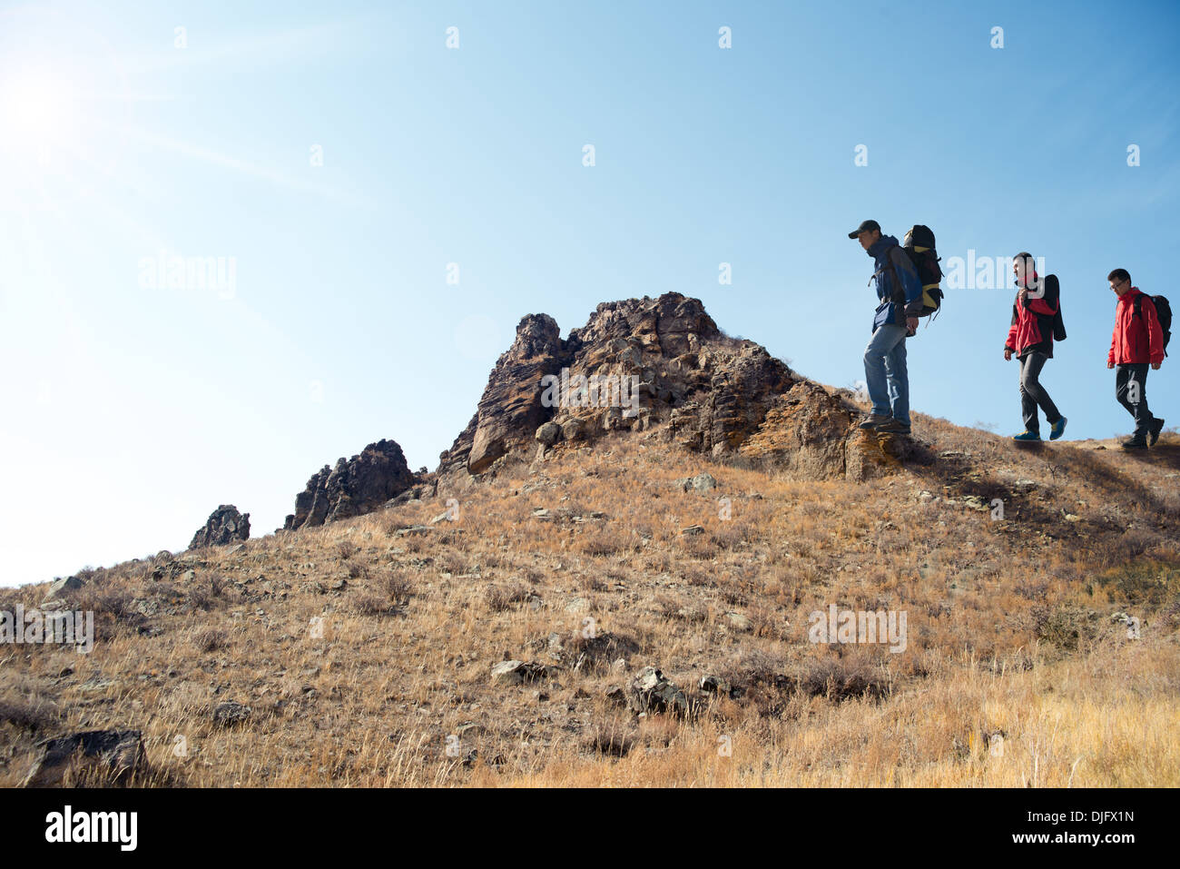 Trekking in hill walking, three people travel Stock Photo