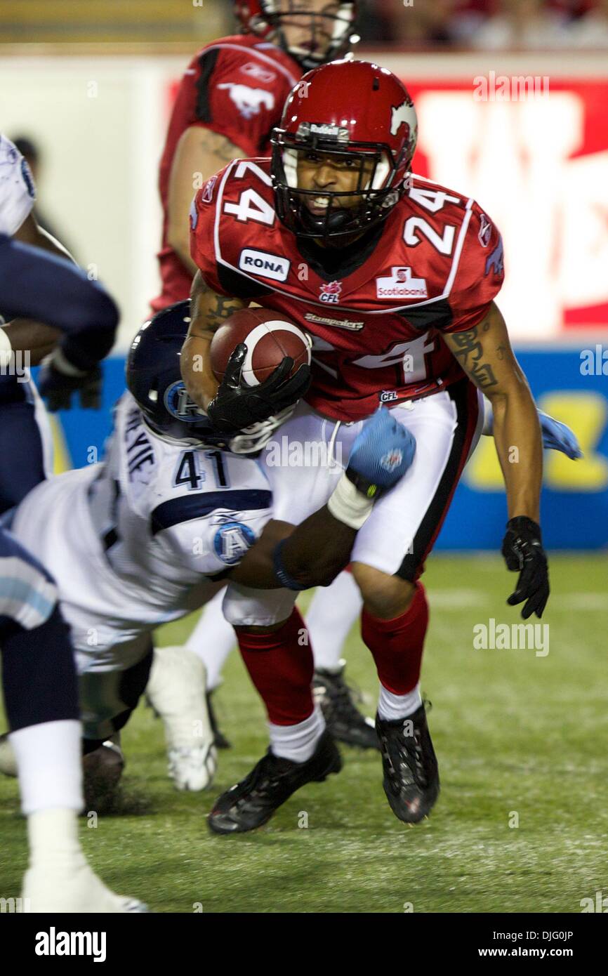 Calgary Stampeders receiver Deon Murphy (24) tries to break free from a