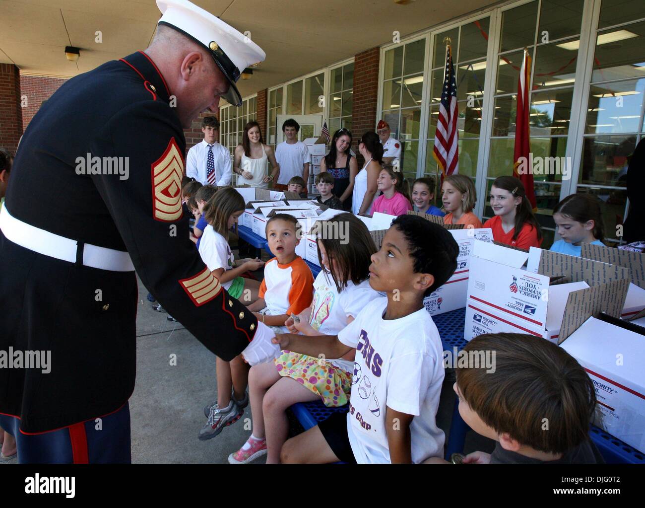 July 02, 2010 - Memphis, Tennessee, U.S. - 2-July 2010- 1st Sgt. Michael Bowen talks to campers, including Peyton Piacenti, on Friday. In celebration of the 4th of July summer campers at St. Agnes-St. Dominic joined members of the Marine Corps Reserves and the Marine Corps League to fill care packages for our military in Afghanistan on Friday. The campers and Marine Reservists fill Stock Photo