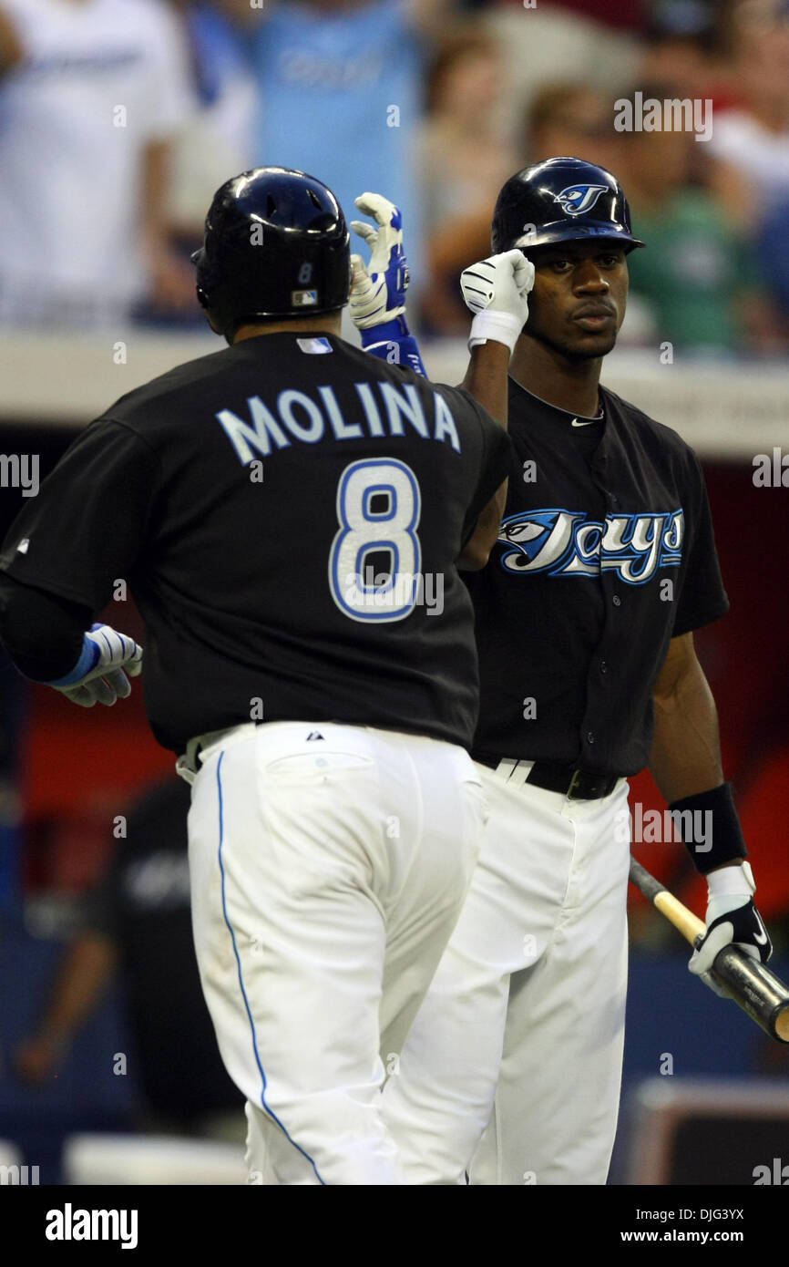 Toronto Blue Jays catcher Jose Molina (8) is congratulated by